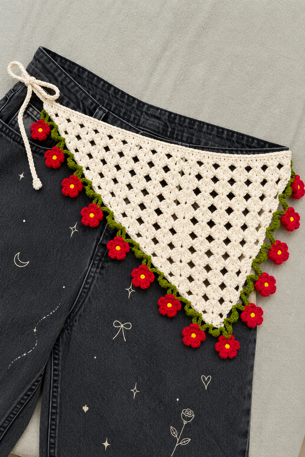 Crochet bandana on dark denim, product styling view