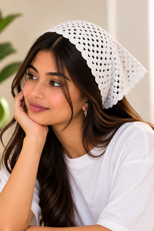 Women's white crochet triangle bandana with scalloped edges, worn as a headscarf