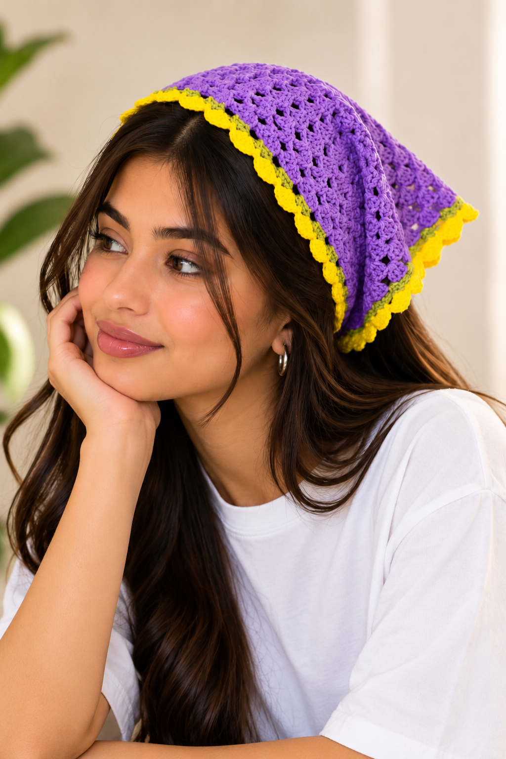 Women's purple crochet bandana with yellow trim, worn as a headscarf